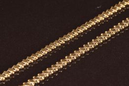 A yellow metal chain made up of circular and spherical links, marked 800, 18g, 64cm