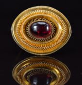 Victorian 9ct gold brooch set with a foiled garnet, verso a glass compartment, 7.9g, 3 x 2.5cm