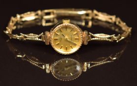 Rotary 9ct gold ladies wristwatch with two-tone hands and baton hour markers, gold dial and quartz