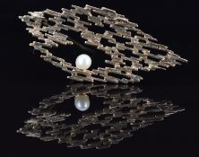 A 9ct gold abstract brooch set with a pearl, 5.8g, 5cm