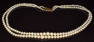 A double strand of cultured pearls with 9ct gold clasp (largest 7.1mm, smallest 3.1mm), , 26.5g,