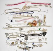 A collection of silver jewellery including three rings, matching necklace and bracelet, pendants,