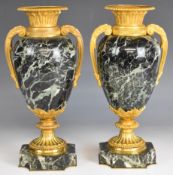 Pair of gilt metal and marble pedestal twin handled urns, height 31cm