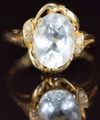 A 14k gold ring set with an oval cut aquamarine and diamonds, 2.5g, size K