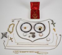 Collection of jewellery, some silver including two rings, an ingot, locket, pendant set with peridot