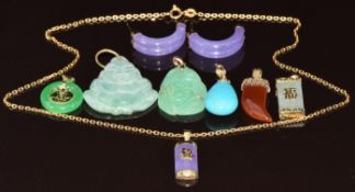 Five jadeite or similar pendants with 9k gold fittings, two other pendants with 9k gold fittings,