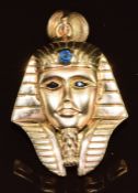 A yellow metal pendant in the form of a pharaoh set with sapphires (tests as 9k gold), 11.5g, 4.2