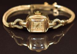 Omega 9ct gold ladies wristwatch with gold hands and hour markers, silver dial and signed 17 jewel