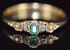 Victorian yellow metal ring set with a foiled emerald and old cut diamonds (testing as 14ct gold),