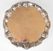 Queen Anne hallmarked silver salver with shaped edge, raised on three feet, Britannia standard marks