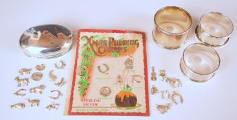 Three various hallmarked silver napkin rings and a hallmarked silver dressing table pot lid,