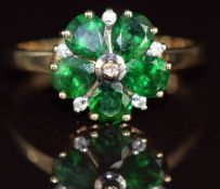 A 9k gold ring set with five pear cut tsavorite garnet and diamonds in a floral cluster, 2g, size N
