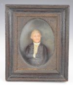 A 19th century wax figure of a distinguished gentleman, in glazed canted oak case with suspension