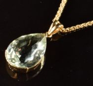 An 18ct gold pendant set with a pear cut aquamarine (2.5cm) on 18ct gold chain (44.5cm), 10g