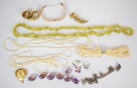 A collection of jewellery including peridot necklace, silver charm bracelet, rolled gold bangle,