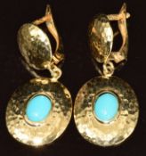 A pair of 18ct gold earrings with hammered decoration set with a turquoise cabochon to each, 4.7g