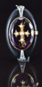 An 18ct gold brooch set with jet, old cut diamonds and paste set with a gold cross and split pearls,