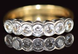 An 18k gold ring set with seven round cut diamonds, each approximately 0.14ct, 4.7g, size P