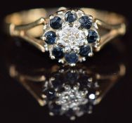 A 9ct gold ring set with a diamond surrounded by sapphires, 1.7g, size O