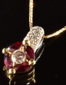 An 18k gold circular pendant set with a diamond of approximately 0.25ct surrounded by four