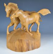Carved wooden figure of two galloping horses with adzed base in the style of Mouseman, signed and