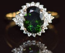 A 9k gold ring set with an oval cut imperial chrome tourmaline of approximately 1.85ct surrounded by