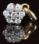 An 18k gold pendant set with diamonds in a cluster, the total carat weight approximately 0.25ct, 1.