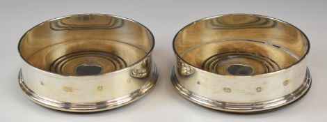 Pair of modern feature hallmarked silver wine bottle coasters, London 1992, maker M C Hersey & Son