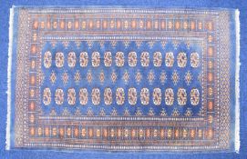 Turkoman rug with twenty six guls on a navy ground, 153 x 97cm