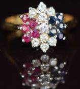 An 18ct gold ring set with diamonds, sapphires and rubies in a cluster, 3.6g, size M