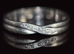 A platinum ring set with diamonds in a cross over setting, 3g, size L