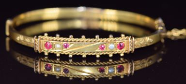 Victorian 9ct gold bangle set with garnets and pearls, 7.1g, 5.8 x 4.7cm