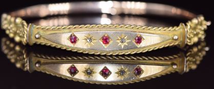 Edwardian 9ct gold bangle set with rubies and diamonds, with rope twist and sphere decoration,