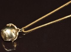 A 9ct gold and silver Masonic ball charm (6.4g) on 18ct gold chain (5.7g, 60cm)