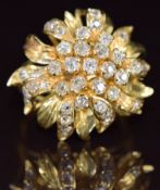 A bespoke 18ct gold ring in the form of a flower set with old cut diamonds, 9.4g, size O