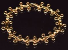 An 18ct gold bespoke bracelet made up of scrolling links by John Watling Goldsmiths of Lacock,