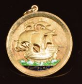 A yellow metal pendant in the form of a carrack with enamel decoration reading 'Portugal', marked