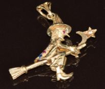A 9ct gold pendant in the form of a witch on a broomstick, set with synthetic gemstones, 7.3g, 4.2 x