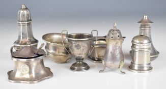 Hallmarked silver peppers, salts and a mustard, together with two spoons to suit and a small