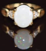 A 9k gold ring set with an opal cabochon and white sapphires, 4.3g, size N