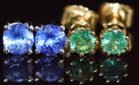 A pair of 18k white gold earrings each set with a round cut tanzanite and a pair of yellow metal