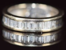 An 18ct white gold half eternity ring set with baguette cut diamonds, the total diamond weight