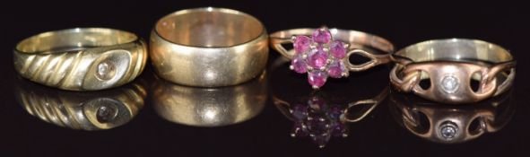 Four 9ct gold rings, one set with a diamond and one white topaz, one a wedding band / ring and one