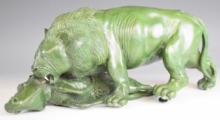 African (likely Zimbabwe) carved green hardstone lion having caught a warthog or similar, signed