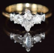 A 14k gold ring set with a marquise cut diamond of approximately 0.5ct and two round cut diamonds,