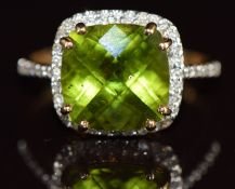 A 9k gold ring set with a Manchurian cushion checker board cut peridot of approximately 3.5ct