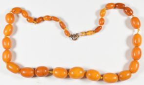 Baltic amber necklace made up of 31 graduated oval beads, the largest 17.7 x 14.3mm and smallest 5.4