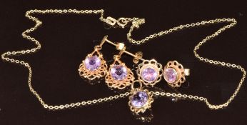 A suite of 9ct gold jewellery comprising earrings and pendant set with amethysts, and another