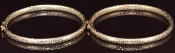 Two 9ct gold bangles with diamond shaped decoration, 14.3g, 5.2 x 5.9cm