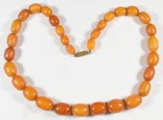 Baltic amber single strand necklace made up of 31 graduated oval beads, 38.3g, the largest 13.6 x
